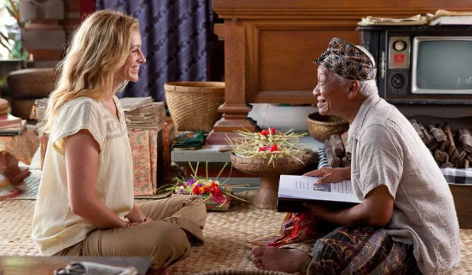 Ketut Liyer, the old Balinese medicine man, drawing on his porch — Liz visiting his village near Ubud, from Eat, Pray, Love (2010)