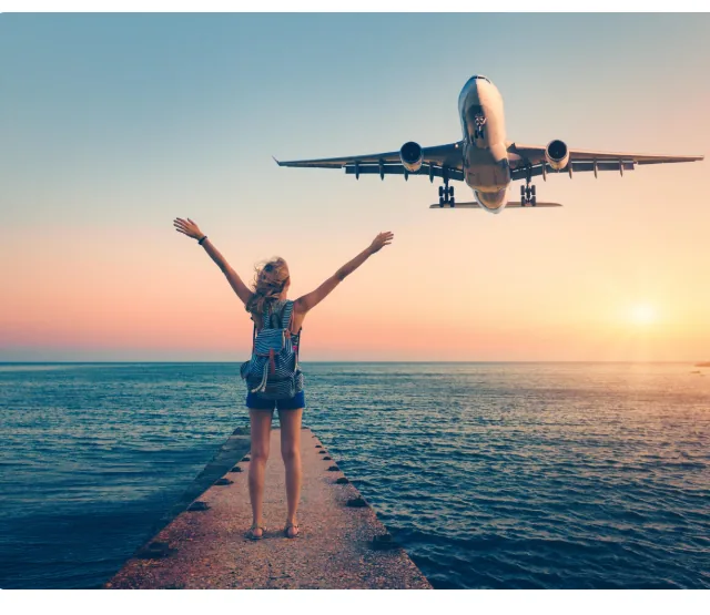 Plane and traveller at sunset over the sea