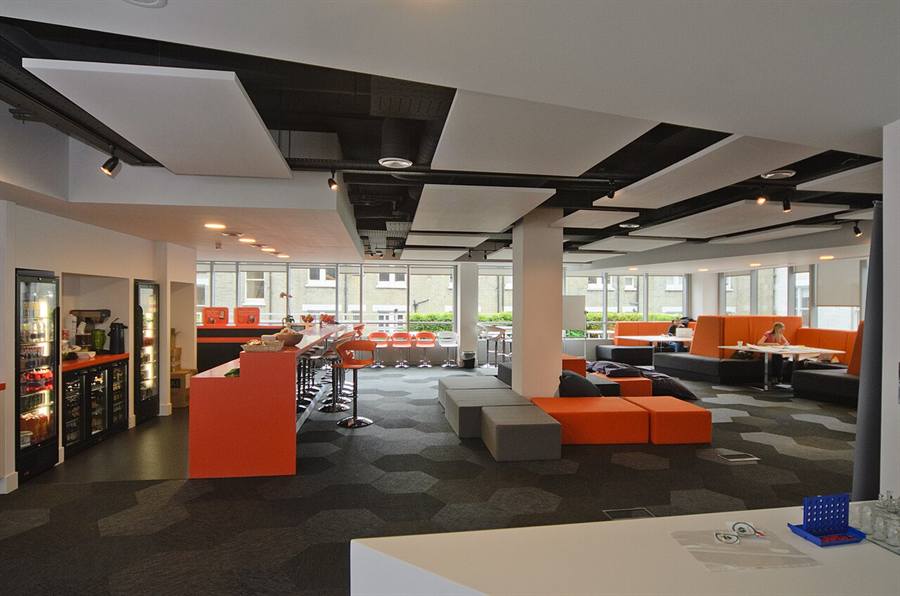 Modern open-plan coworking space with desks and lounge area