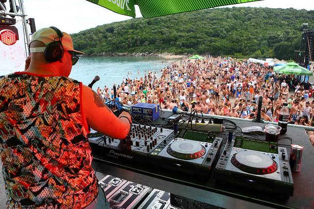 Sea Dance Festival open-air stage with sunset and crowd by the Adriatic in Montenegro